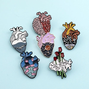 Detailed set of 6 enamel pins featuring anatomical heart, brain, and floral designs