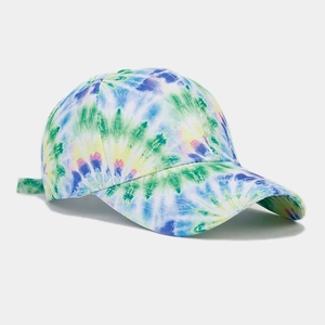 Detailed close-up of rainbow tie-dye baseball cap showing cotton canvas texture and stitching