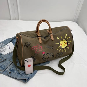 Olive green travel bag with colorful graffiti prints and adjustable brown shoulder strap