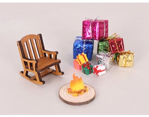 Miniature wooden rocking chair with colorful gift boxes and a micro campfire display