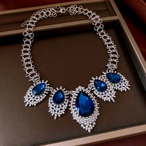 Macro detail of royal vintage necklace with teardrop blue stones and silver accents