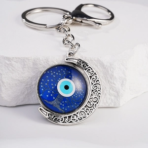 Silver moon keychain with blue Turkish evil eye charm and hollow tree texture