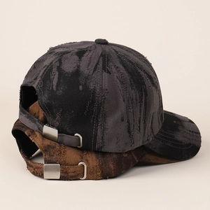 Detail of vintage tie-dye baseball caps with distressed edges and metal buckle strap
