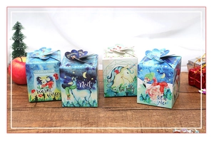 Detailed view of four illustrated Christmas gift boxes with festive patterns on wood surface