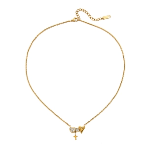 Detailed macro view of 18K gold stainless steel necklace with diamond heart and cross pendant