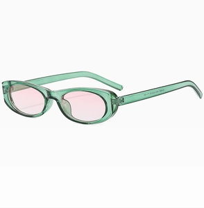 Detail view of transparent green cat eye sunglasses with light pink tinted lenses