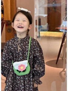 Close-up of handmade knit crossbody bag and candy-shaped hairband for children