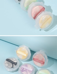 Detail shot of marble pattern finger powder puffs in transparent storage boxes