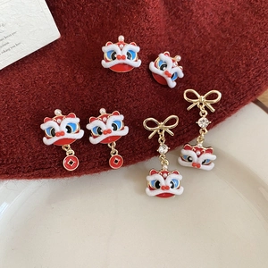 Detail of red enamel lion dance earrings and brooch with pearls and coins
