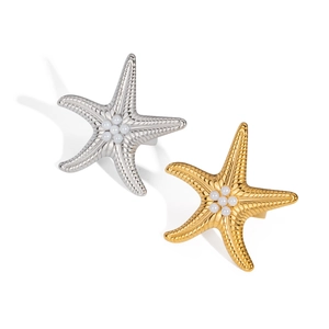 Gold and silver starfish napkin rings with pearl accents on a white background