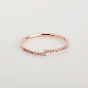 Minimalist rose gold open ring with crisscross ends and small shimmering crystals