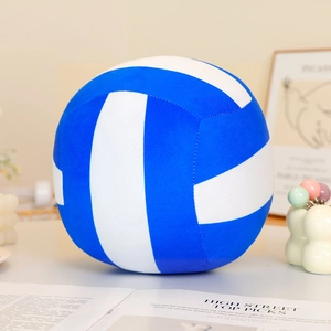 Detailed view of a soft blue and white striped plush volleyball pillow in a cozy home setting