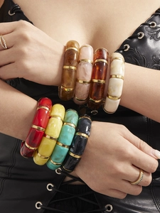 Detail view of multi-color resin bamboo bracelets with golden metal spacers
