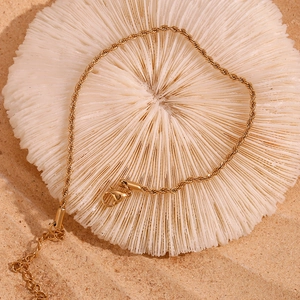 Detailed close-up of 2mm twisted rope chain anklet in 18K gold-plated stainless steel