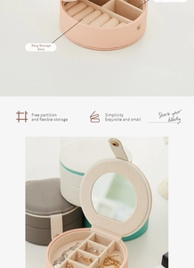 Detail view of portable jewelry box with adjustable dividers and built-in mirror