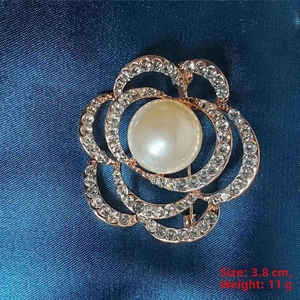 Detail view of camellia brooch with pearl and rhinestones measuring 3.8 cm and 11 g