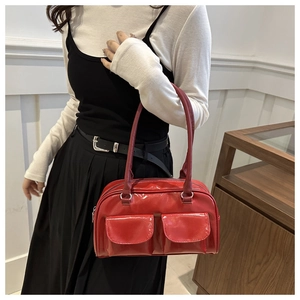 Glossy red faux leather shoulder bag with vintage dual front pockets and silver metal rings