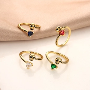 Adjustable skull rings with heart-shaped colorful cubic zirconia on beige silk fabric
