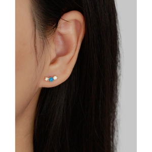 Luxurious S925 silver opal stud earrings with zircon accents worn on earlobe