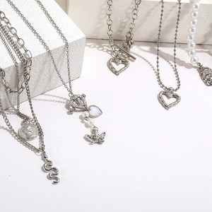 Detailed view of silver fashion jewelry set with heart and snake charms on stone blocks