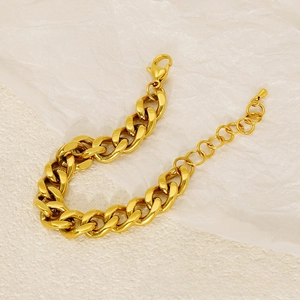 Detail view of bold gold cuban chain bracelet with lobster clasp and extension chain