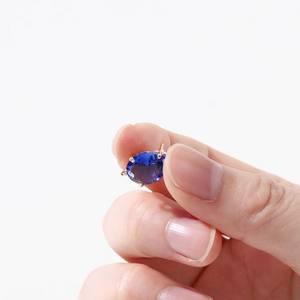 Macro shot of 14k gold-plated blue zircon pendant with four-prong setting detail