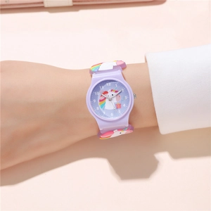 Detail of purple silicone kids watch featuring a colorful unicorn design on a child wrist