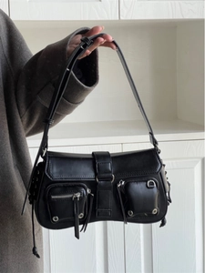 Close-up of black Y2K underarm bag with double zipper pockets and metal D-ring hardware