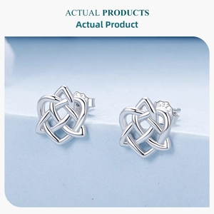 Macro shot of S925 sterling silver heart celtic knot stud earrings on blue display