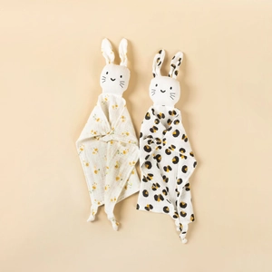 Detail of two cotton muslin security blankets with floral and leopard prints for infants