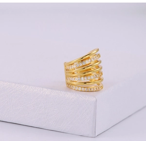 Macro view of multi-layer gold-plated ear cuff featuring sparkling cubic zirconia stones