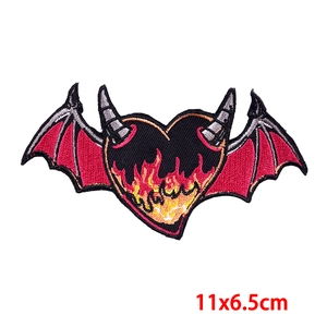 Cartoon embroidered black heart patch with wings and horns, measures 11x6.5cm