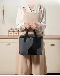 Close-up of grey and black insulated lunch bag with thickened handle in a kitchen setting