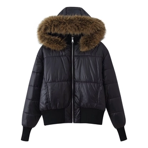Detail of black winter jacket featuring fluffy brown faux fur collar and ribbed windproof cuffs
