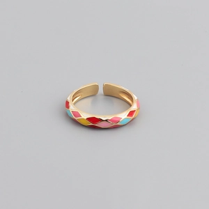 Macro shot of colorful diamond-pattern oil drip inlay on adjustable gold geometric ring