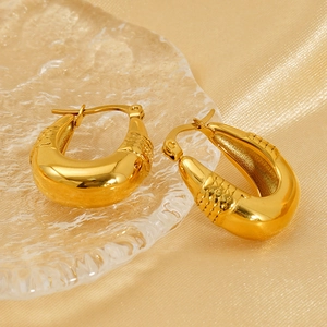 Polished 18K gold plated chunky U-shaped hoop earrings with texture on silk background