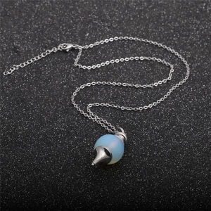Blue opal bead pendant necklace with silver metal spike and O-chain on black background