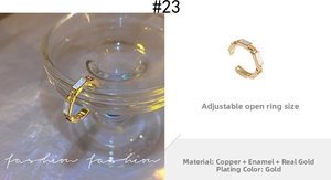 Detail of adjustable gold ring with white drip oil rectangular modules in close-up view