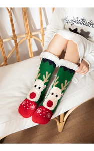 Detailed knit texture of Christmas reindeer socks with thick white fleece lining