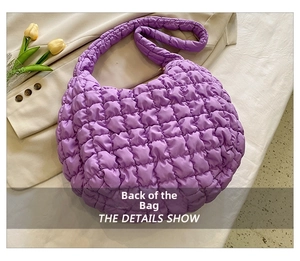 Macro shot of purple quilted cloud tote bag texture and soft padded shoulder strap