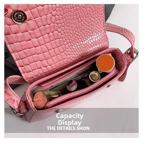 Internal view showing storage space for cosmetics inside the pink crocodile pattern handbag