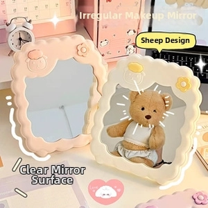Detail of wavy cream white makeup mirror featuring a cute 3D sheep and floral relief design