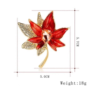Detailed size view of red enamel maple leaf brooch with dimensions 5.7cm by 5.0cm