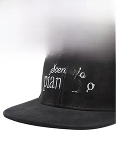 Detailed close-up of white scenario planning embroidery on black cotton flat brim cap