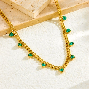 Golden Cuban chain necklace featuring vibrant green heart-shaped rhinestone pendants