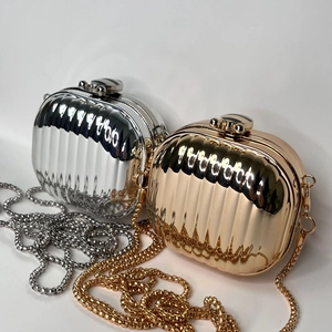 Mini acrylic hard shell clutch bags in gold and silver with metallic striped texture