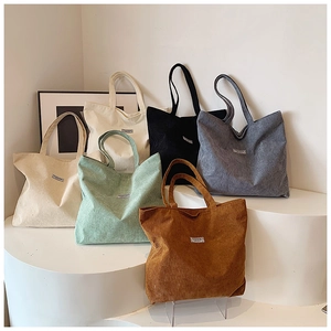 Minimalist corduroy tote bags for women in multiple colors with fashion label on display