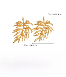 Detailed view of oversized gold leaf earrings with textured zinc alloy finish