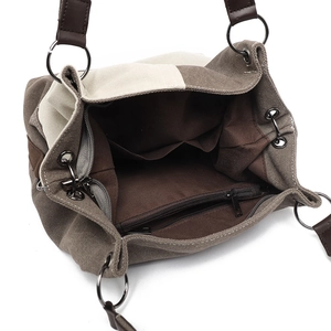 Minimalist canvas tote bag with brown leather straps and spacious interior pockets