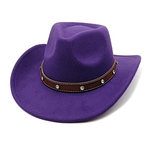 Detail of purple felt cowboy hat featuring a brown leather band with sparkling rhinestones